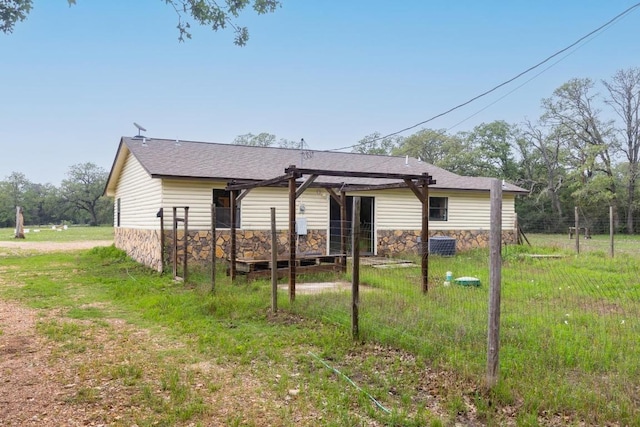 326 Zapalac Rd, Smithville, TX 78957 - rear view of house featuring stone siding and roof with shingles