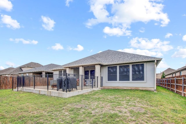 back of property with a patio area and roof with shingles
