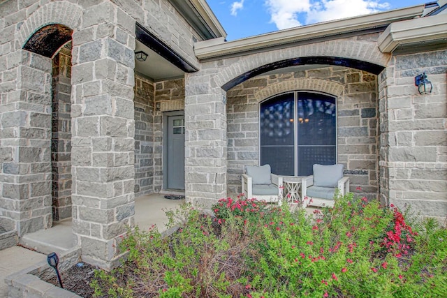 property entrance featuring stone siding