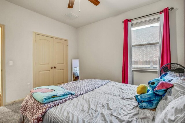 carpeted bedroom featuring multiple windows, a closet, baseboards, and ceiling fan