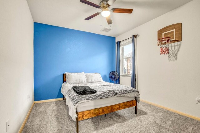 carpeted bedroom featuring baseboards and a ceiling fan