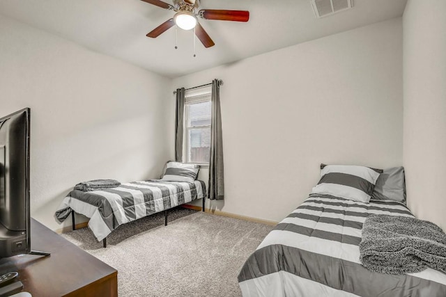 carpeted bedroom featuring baseboards and a ceiling fan