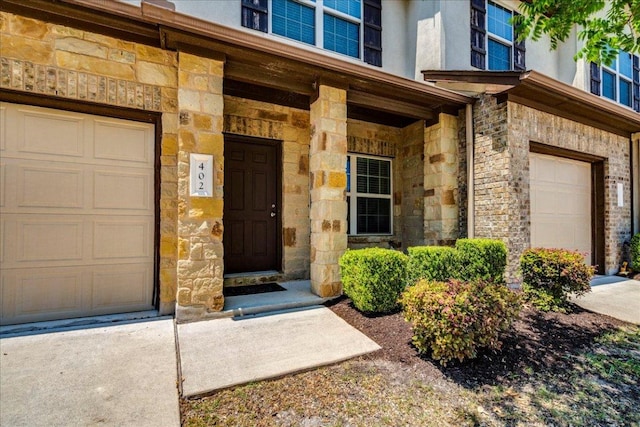 1701 S Bell Blvd Unit 402, Cedar Park, TX 78613 - property entrance with stone siding and an attached garage