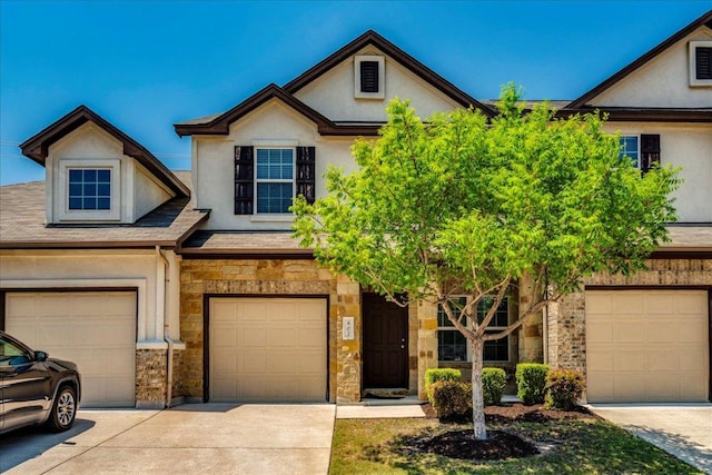 1701 S Bell Blvd Unit 402, Cedar Park, TX 78613 - view of property with stone siding, driveway, stucco siding, and a garage