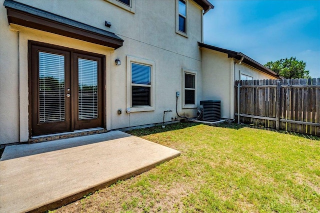1701 S Bell Blvd Unit 402, Cedar Park, TX 78613 - doorway to property with central air condition unit, stucco siding, a patio area, and french doors