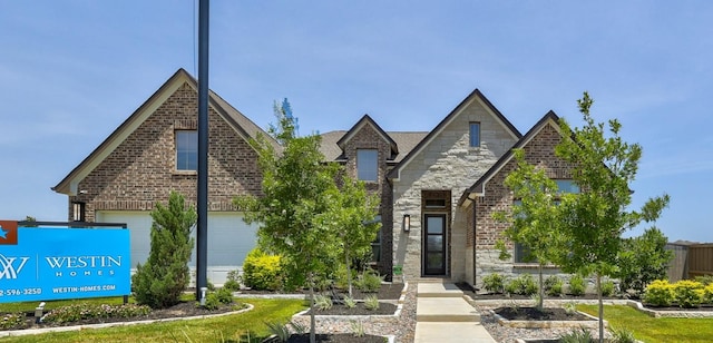 105 Isaac White Dr, Bastrop, TX 78602 - view of front facade featuring brick siding, stone siding, and a garage