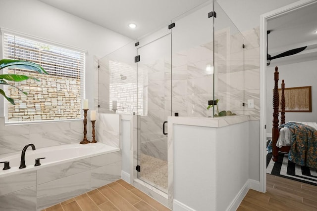 147 Epoch Dr, Austin, TX 78737 - full bath with a bath, connected bathroom, wood finish floors, a stall shower, and recessed lighting
