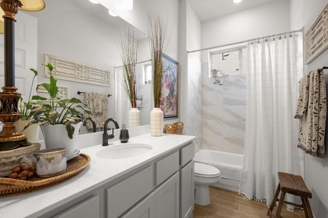 147 Epoch Dr, Austin, TX 78737 - full bath with toilet, shower / bath combo with shower curtain, wood finish floors, and vanity