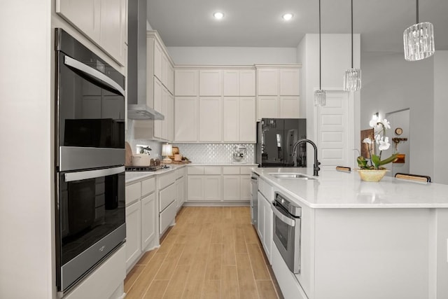 147 Epoch Dr, Austin, TX 78737 - kitchen with appliances with stainless steel finishes, light wood-style floors, tasteful backsplash, light countertops, and recessed lighting