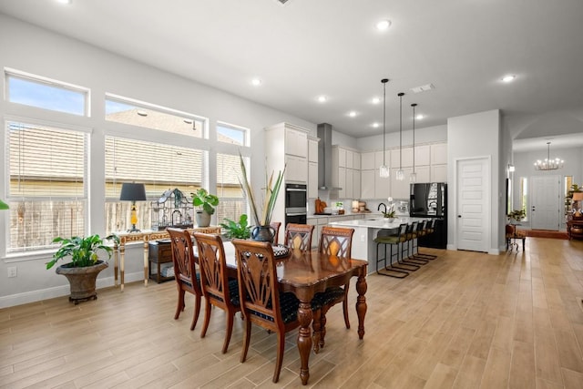 147 Epoch Dr, Austin, TX 78737 - dining room with light wood-style flooring, baseboards, recessed lighting, and a chandelier