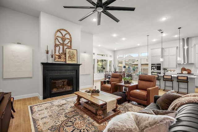 147 Epoch Dr, Austin, TX 78737 - living area featuring a ceiling fan, light wood-type flooring, recessed lighting, and a tiled fireplace