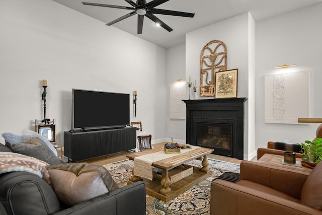 147 Epoch Dr, Austin, TX 78737 - living room with wood finished floors, a ceiling fan, a glass covered fireplace, and vaulted ceiling