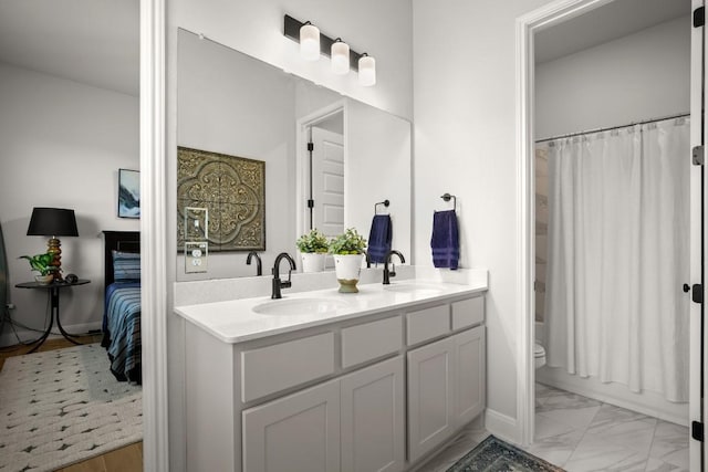 147 Epoch Dr, Austin, TX 78737 - full bath with double vanity, marble look tiles, and toilet