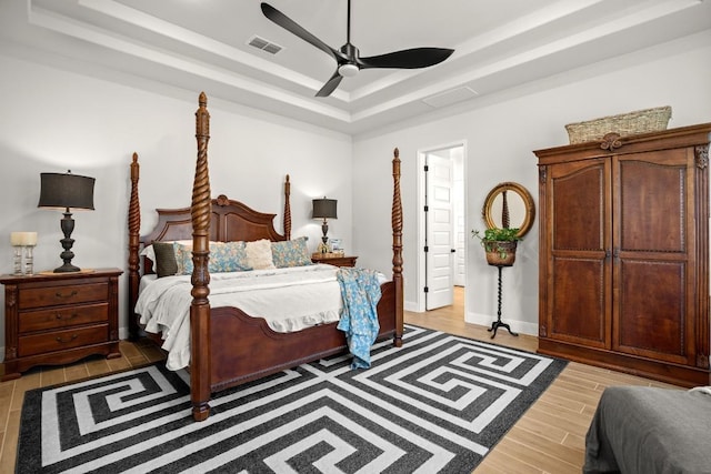 147 Epoch Dr, Austin, TX 78737 - bedroom with a raised ceiling, light wood-style floors, and ceiling fan