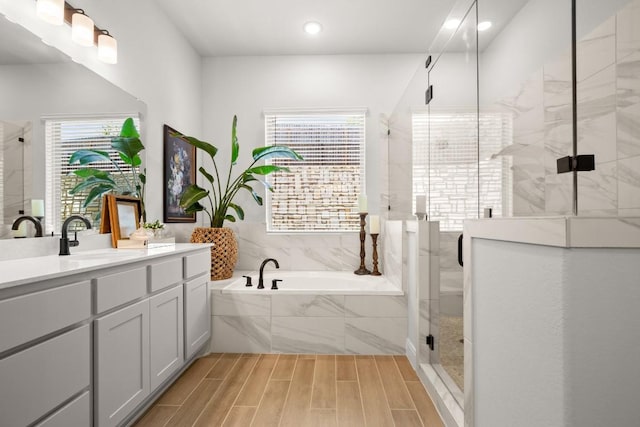 147 Epoch Dr, Austin, TX 78737 - bathroom with a garden tub, a shower stall, vanity, recessed lighting, and wood finished floors