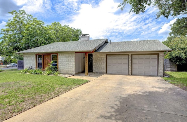 10500 Berthound Dr, Austin, TX 78758 - view of front of property with a garage, a front lawn, driveway, brick siding, and a chimney