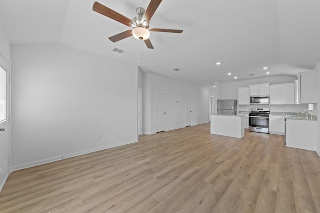 435 Aplite Pass, Maxwell, TX 78656 - unfurnished living room with vaulted ceiling, a sink, recessed lighting, ceiling fan, and light wood-type flooring