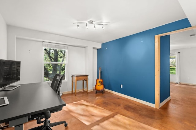 office area featuring finished concrete floors and baseboards
