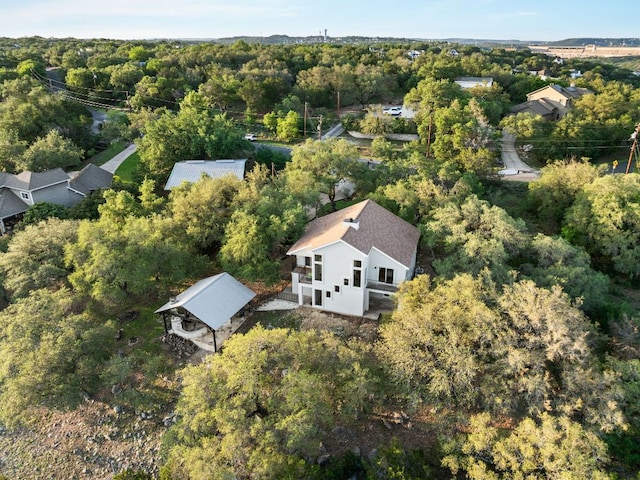 view of subject property with a heavily wooded area