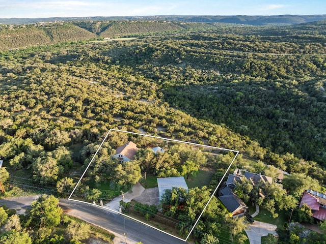 aerial overview of property's location featuring property boundaries highlighted and a heavily wooded area