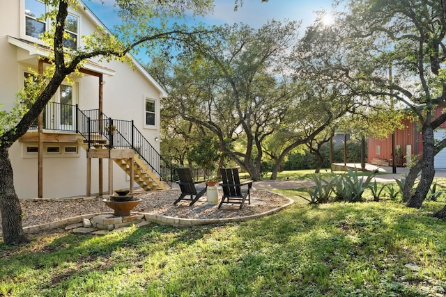 view of grassy yard with stairway
