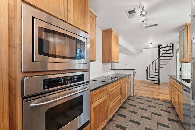 kitchen featuring stainless steel appliances and dark countertops