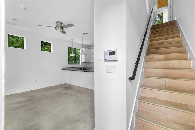 1314 Delano St Unit B, Austin, TX 78721 - staircase with ceiling fan, concrete floors, and baseboards