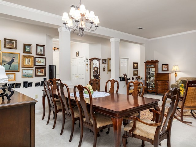 101 Chickadee Cv, Georgetown, TX 78633 - dining space featuring ornamental molding, a chandelier, ornate columns, light colored carpet, and baseboards
