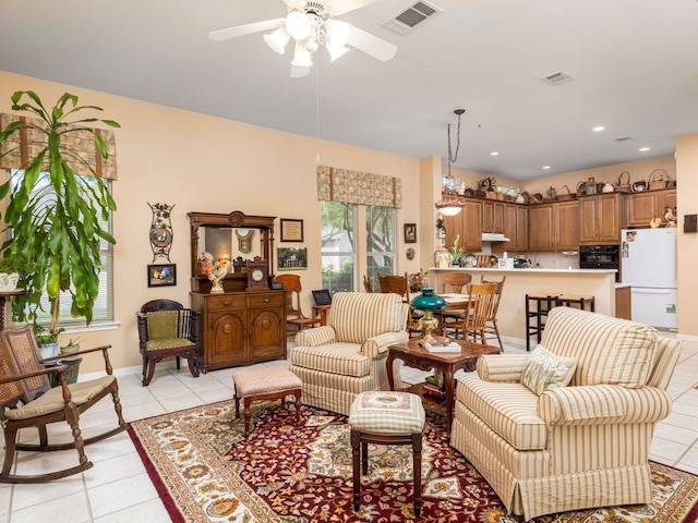 101 Chickadee Cv, Georgetown, TX 78633 - living area featuring light tile patterned floors, a ceiling fan, and baseboards