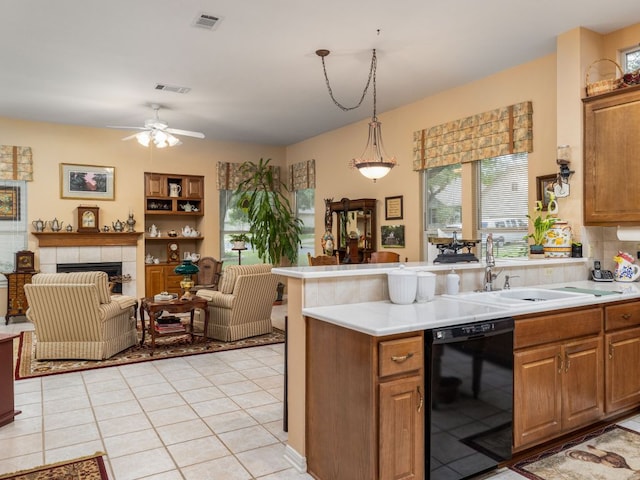 101 Chickadee Cv, Georgetown, TX 78633 - kitchen featuring dishwasher, open floor plan, a sink, light tile patterned flooring, and light countertops
