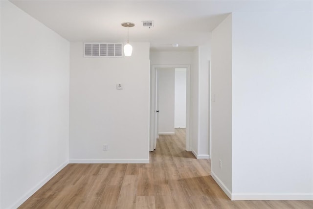 unfurnished room featuring light wood-style floors and baseboards