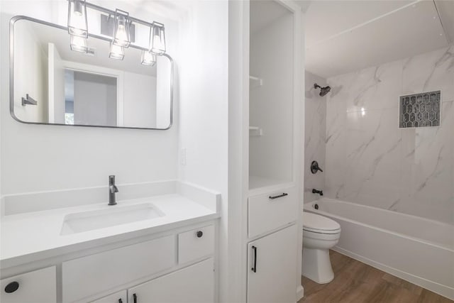 full bathroom featuring toilet, vanity, wood finished floors, and shower / washtub combination