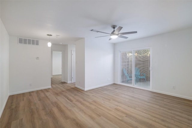 empty room featuring light wood-style flooring, baseboards, and a ceiling fan