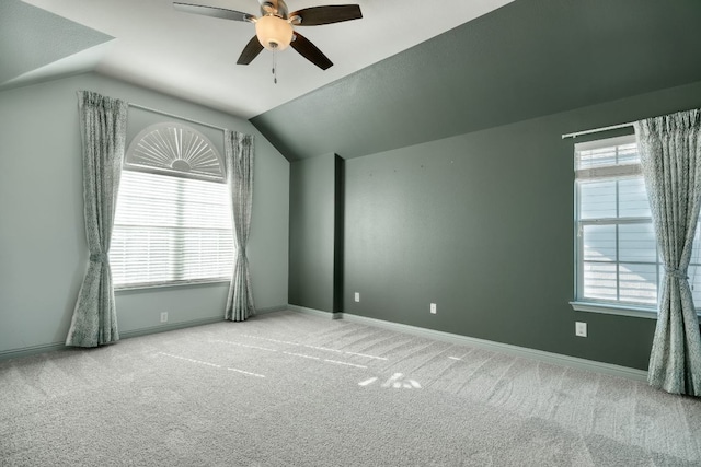 bonus room with a ceiling fan, vaulted ceiling, plenty of natural light, carpet flooring, and baseboards