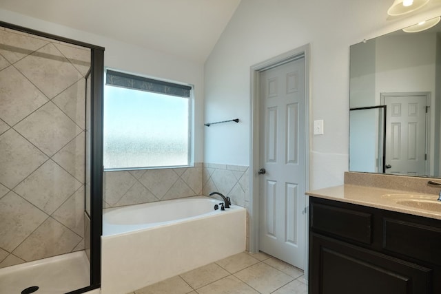 full bath with tile patterned flooring, lofted ceiling, a stall shower, vanity, and a bath