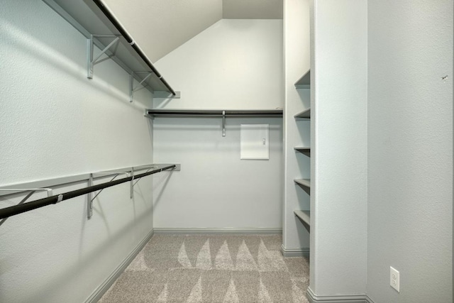 spacious closet with carpet and vaulted ceiling