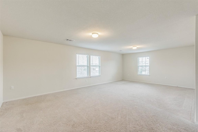 11905 Reindeer Dr, Austin, TX 78754 - empty room with light colored carpet and a textured ceiling