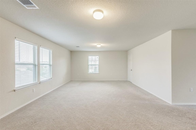 11905 Reindeer Dr, Austin, TX 78754 - empty room featuring light carpet, a textured ceiling, and baseboards