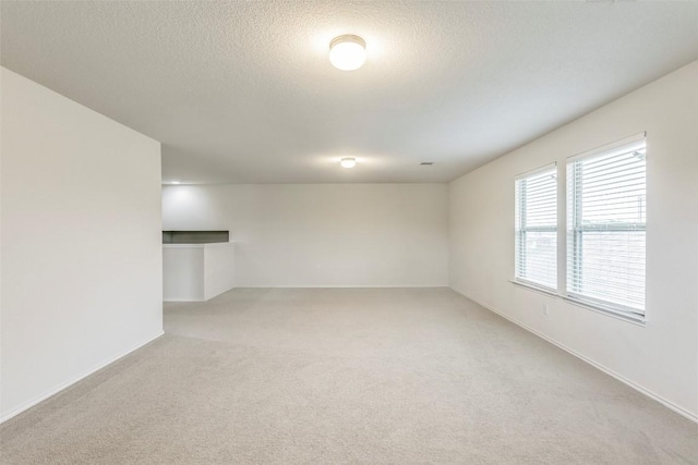 11905 Reindeer Dr, Austin, TX 78754 - empty room featuring light colored carpet, a textured ceiling, and baseboards
