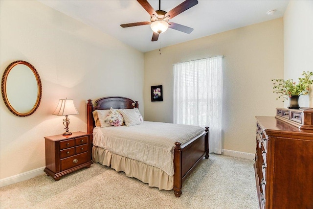bedroom with baseboards, light colored carpet, and a ceiling fan