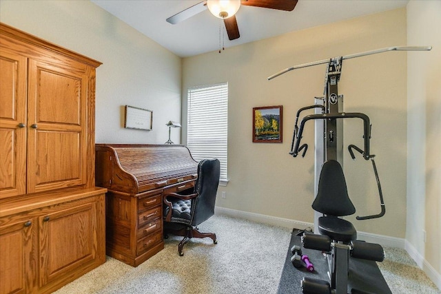 office space featuring a ceiling fan, light colored carpet, and baseboards