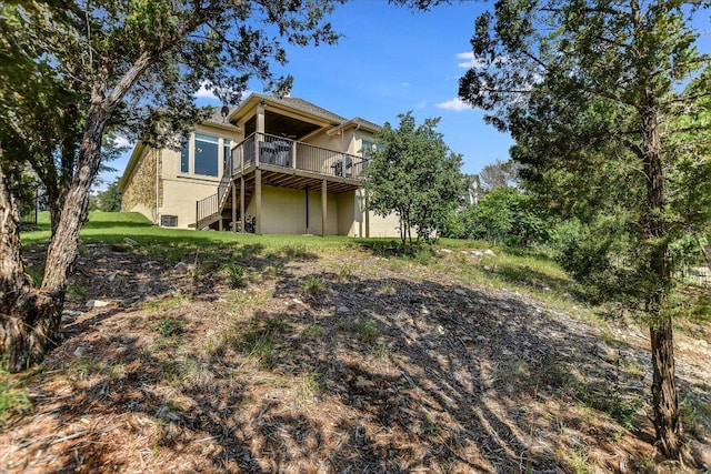back of property featuring a deck and stucco siding