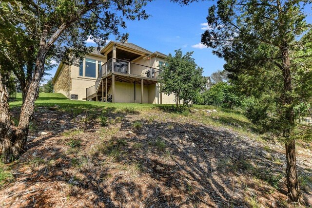 19440 Serenity Ln, Lago Vista, TX 78645 - rear view of property with a deck, stairway, and stucco siding