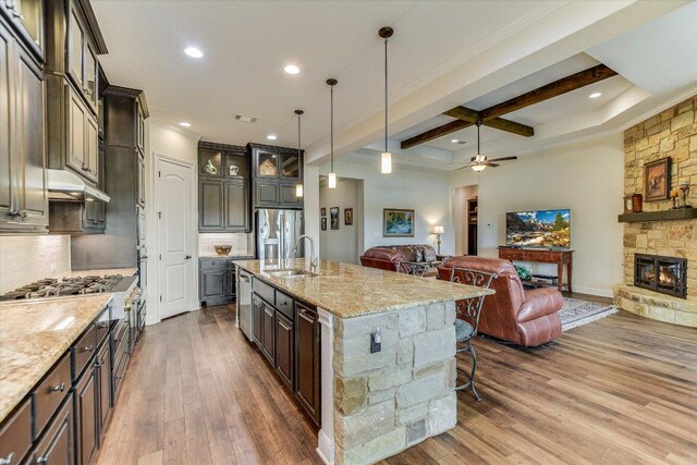 19440 Serenity Ln, Lago Vista, TX 78645 - kitchen featuring open floor plan, coffered ceiling, wood finished floors, beam ceiling, and backsplash