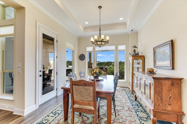 19440 Serenity Ln, Lago Vista, TX 78645 - dining area featuring a chandelier, light wood-type flooring, a raised ceiling, ornamental molding, and baseboards
