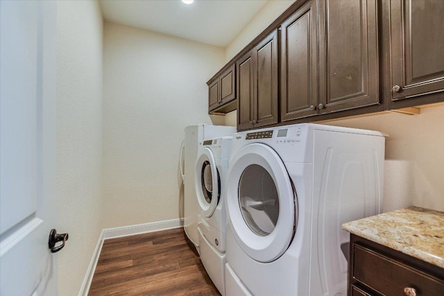 19440 Serenity Ln, Lago Vista, TX 78645 - laundry room with cabinet space, washing machine and dryer, baseboards, and dark wood-style flooring