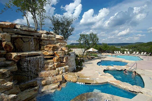 19440 Serenity Ln, Lago Vista, TX 78645 - community pool with a patio area and a hot tub