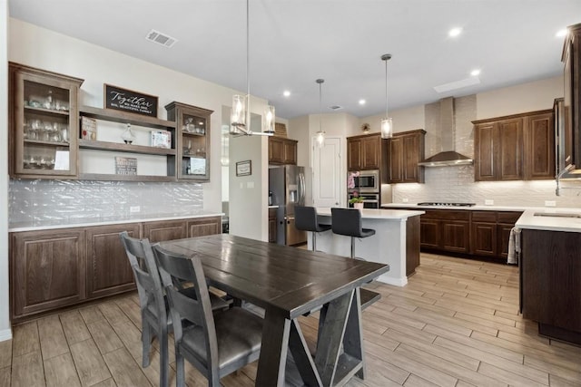 dining room with light wood-style floors and recessed lighting