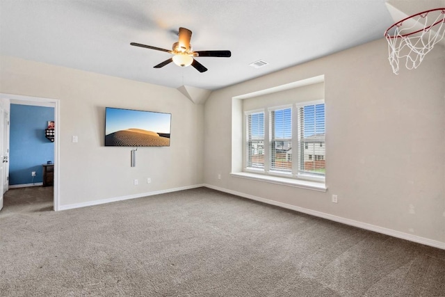 carpeted spare room with ceiling fan and baseboards