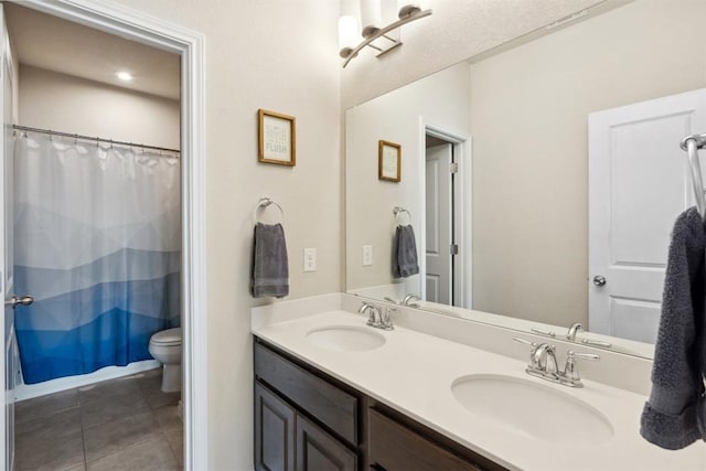 bathroom featuring tile patterned floors, toilet, double vanity, and a shower with shower curtain